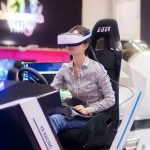 Beautiful girl on VR Racing Simulator